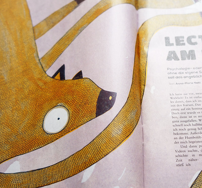 Cropped close-up photo of a spread in the magazine, the spread has an illustration of a fictional character which looks like a mix between a sloth, cat and octopus, it is reaching from one page to the next, and on the next page there is part of a column of text to be seen.